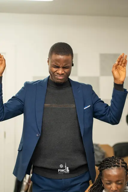A man worshipping with hands raised