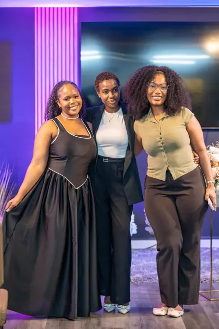 Three young women smiling together at church