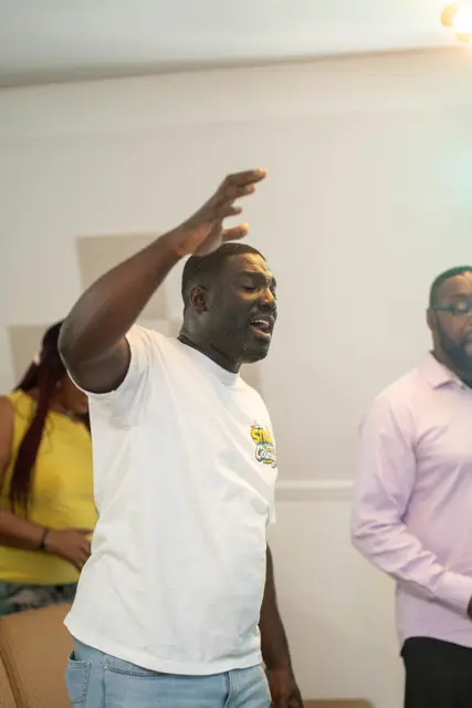 A man worshipping with his hand raised