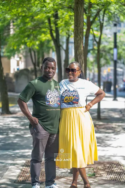 Two members in Gospel in the City t-shirts downtown
